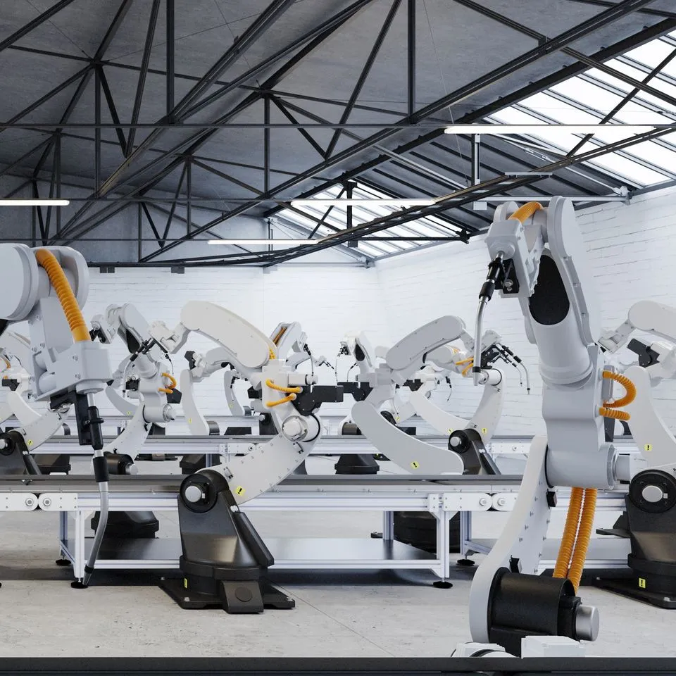 Factory assembly line with mechanical arms arrayed along a conveyer belt