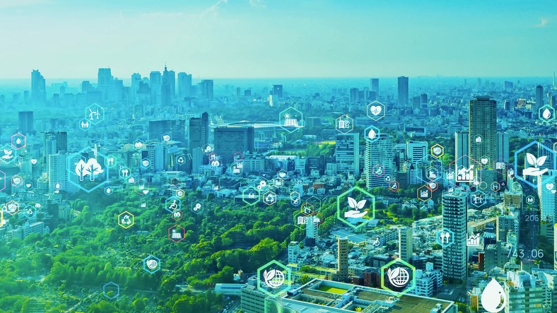 View of city with greenery in the foreground with sutainability themed icons overlaid